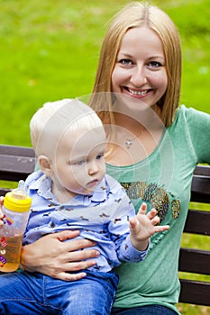 Young mother holds on hands of his two year old son