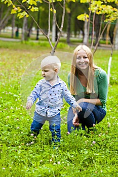 Young mother holds on hands of his two year old son