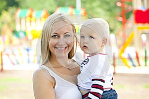 Young mother holds on hands of his two year old son