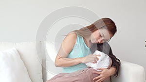 Young mother hug and take care her fever daughter