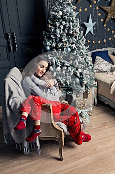 Young mother hugs daughter in pajamas holding her in her arms