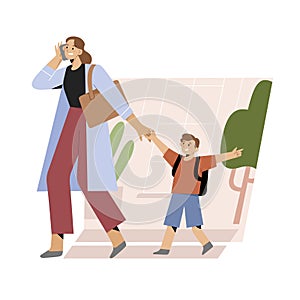 Young mother hurrying to office walking her child to school or kindergarten, talking on the phone while her son