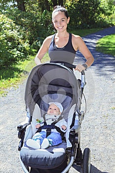 Young mother jogging with a baby buggy