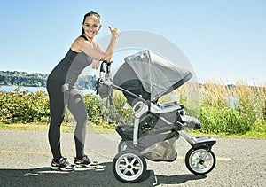 Young mother jogging with a baby buggy