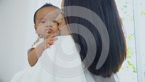 Young mother kissing on cheek baby photo