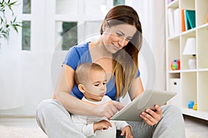 Young mother larning child how to use tablet photo