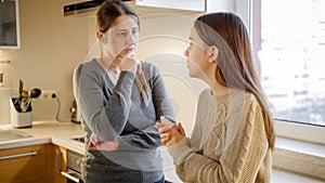 Young mother listening and talking to her teenage daughter complaining about problems and depression. Parent supporting