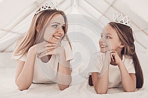 Young Mother and Little Doughter wearing Tiaras