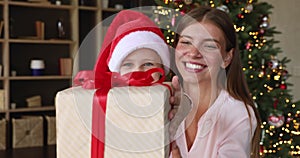 Young mother and little girl congratulate with Christmas by videocall