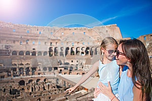 Young mother and little girl exploring Coliseum inside in Rome, Italy. Family portrait at famous places in Europe