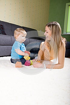 Young mother playing with baby boy