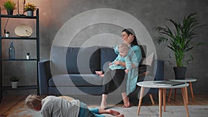 Young Mother Playing with Children on the Couch. happy family. home comfort.