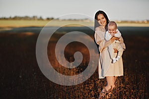 Young mother playing with her baby. Mom and son walking in a park. happy mom playing with her son. Mother`s Day. happy parents.