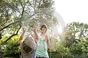 Young mother playing with her child outdoors