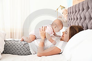 Young mother playing with her cute baby