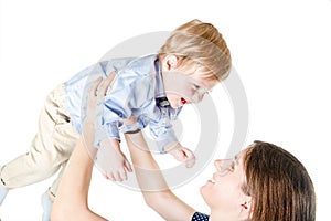 Young mother playing with one year son on white background