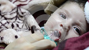 Young mother playing with a pacifier with two months