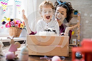 Young Mother Presenting Easter Bunny to Son