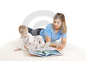 Young mother reading book with her little daughter