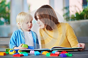 Young mother reading book to her son