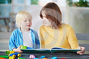 Young mother reading book to her son