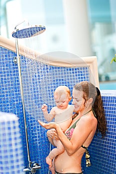 Young mother showing shower to her baby