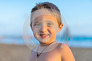 Young mother and smiling baby boy son playing on the beach on the Sunset. Positive human emotions, feelings, joy. Funny cute child