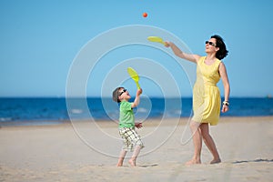 Young mother and son playing on the beach