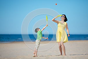 Young mother and son playing on the beach