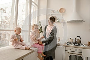 A young mother spends time with her little daughters at home. photo