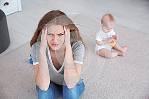 Young mother suffering from postnatal depression and little baby