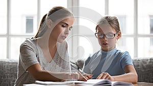 Young mother and teen daughter ho home task together