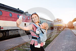 Young mother travelling with baby by train.