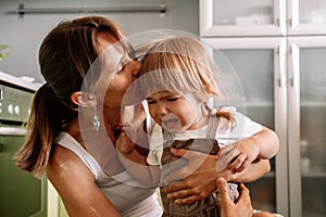 Young mother tries to calm her crying little daughter. Raising  child concept
