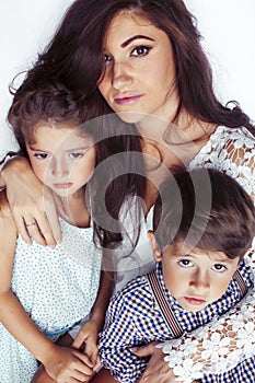 young mother with two children on white background isolated, happy smiling family, lifestyle people concept