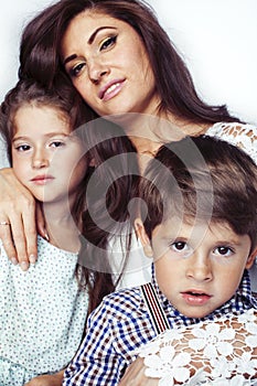 young mother with two children on white background isolated, happy smiling family, lifestyle people concept