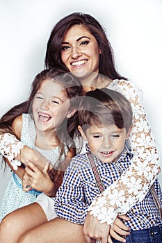 young mother with two children on white background isolated, happy smiling family, lifestyle people concept