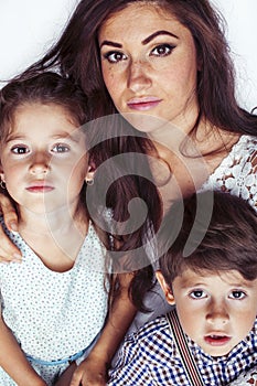 young mother with two children on white background isolated, happy smiling family, lifestyle people concept