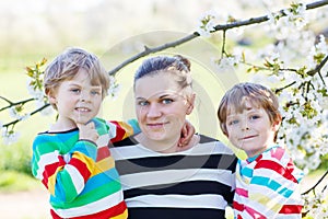 Young mother and two little twins boys having fun