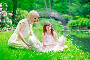 Young mother and two sisters in park