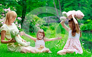 Young mother and two sisters in park