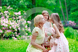 Young mother and two sisters in park