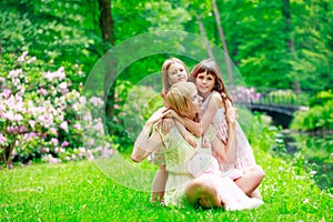 Young mother and two sisters in park