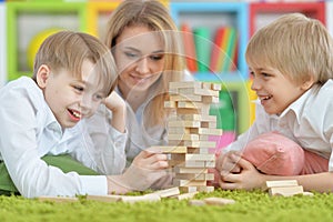 Young mother and two sons playing