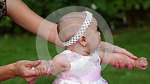 Young mother walking with her little baby girl