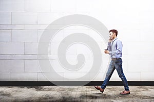 Young motivation Businessman talk via smart phone while walk out photo