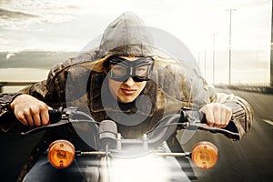 Young motorcyclist driving on a road