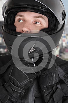 Young motorcyclist man wearing helmet photo
