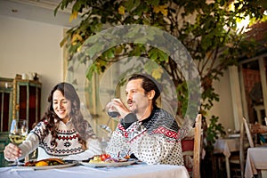 Young multi-ethnic couple having a great time in restaurant