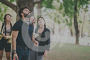 Young multicultural students collaborating on a school project in the park